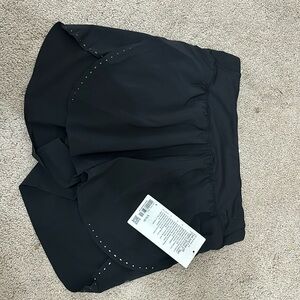 Size 6 lululemon shorts NWTs. Black with reflective spots classic fit.
